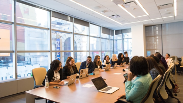 Group of people sitting around a conference table